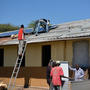 Placement des premiers panneaux solaires sur le toit des classes.